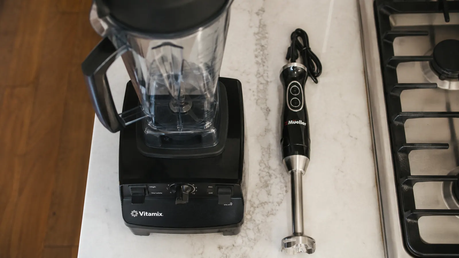 Mueller immersion blender disassembled next to a countertop jar blender, showing dramatic size difference for small kitchen storage comparison